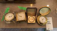 Four clocks side by side on countertop