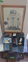 Overview of all items on small table including framed certificate, three medal cases, wallet