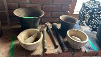 Group view of two ceramic mortars, two metal mortars, three metal pestles, wooden/ceramic pestle and ceramic tip