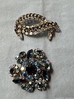 Sherman curved brooch and Triad round brooch together