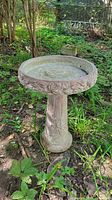 Full view of assembled bird bath in garden setting