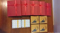 Five red gift boxes, one open cigarette case, four boxed cigarette cases