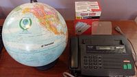 Globe, fax machine, and paper rolls group view