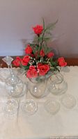 Full lot showing flower arrangement, three vases, four crystal holders