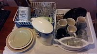 Overall view showing Brita pitcher, plates, mugs, glassware, tin, carafe, serveware