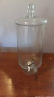 Full view of glass beverage dispenser with lid and spigot