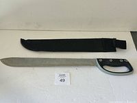 Machete and sheath laid flat