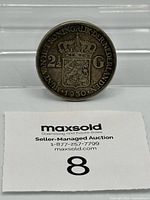 Full coin with lot tag for scale