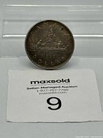 Coin standing displaying reverse Voyageur design and 1938 date