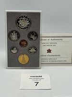 Front view of proof set with seven coins and COA