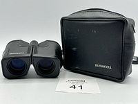 Binoculars front view beside carrying case