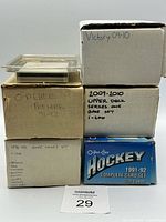 Stack of five labelled card boxes showing set names and years