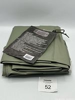 Folded Jackfield rain jacket with hang tag visible