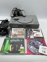 Console, cords, controller, four game cases