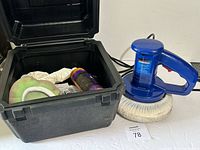 Polisher beside open case showing accessories inside