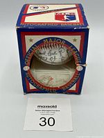 Front view of boxed autographed baseball showing signatures and Blue Jays logo cube