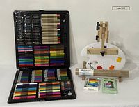 Full lot showing open art kit, easel, palette, craft roll, paint stick box and acrylic paint box