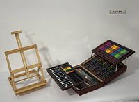 Wood tabletop easel and open art supply case showing contents