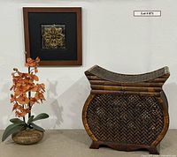 Full lot showing orchid, wall art, woven chest