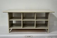 front view of solid wood coffee table showing six cubbies