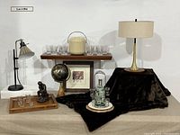 All items grouped: tray, lamps, glasses, ice bucket, sculpture, caddy, print, fur throw, shelf, globe