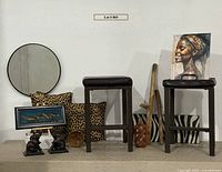 Full lot showing stools, mirror, pillows, framed gazelles, elephant bookends, rain sticks, zebra panel, canvas portrait
