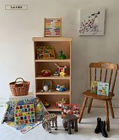 Full lot view showing shelf, toys, artwork, blanket, basket, stools, boots and books