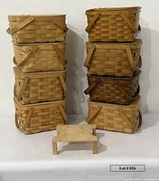 Front view of two stacks of four pie baskets each, small wood shelf in foreground