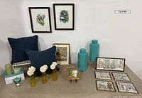 Overall lot layout showing pillows, canisters, artwork, prints, tray and candles