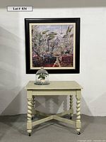 Full lot view showing table, framed art and cloche