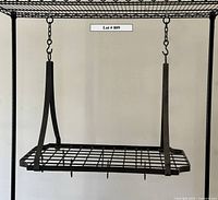 Front view of rectangular steel pot rack suspended by straps and chains