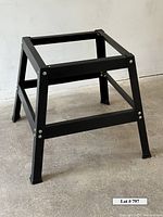 Front-angle view of black steel table saw stand