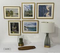 Overview showing five framed Monet prints, lamp, tray, candle holder and candle
