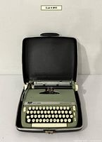Typewriter seated in open carrying case viewed from above