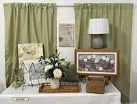 Full lot showing curtains, wall art, lamp, basket, tray, stars, vase arrangement