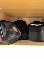 Front view of three bags on shelf