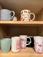 Full view of both shelves showing all mugs