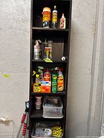 Full view of shelving with chemicals, insecticides, adhesives, storage bins