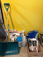 Overall lot showing shovel, salt bags, jug, canister and boxed items