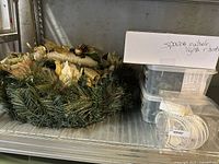 Wreath, spare parts boxes, Haggu bulb pack on shelf
