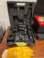 Kit opened showing drill, battery, charger and case interior