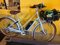 Left side view of Electra Loft Go! e-bike showing frame, battery, rear rack and basket