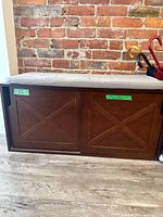 Front view of shoe bench with cushion and closed sliding doors