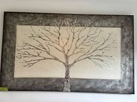 Full view of framed textured bare tree artwork, shows design and frame