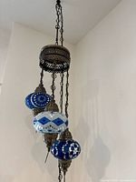 Full view of chandelier showing canopy, chains and three mosaic globes
