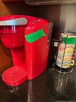 Front view of red Keurig coffee maker with mug carousel