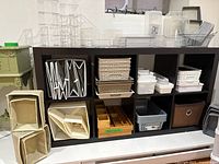 Overall view of IKEA 8-cube shelf loaded with various storage items