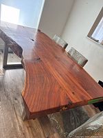 Full view of live-edge rosewood dining table with chairs for scale