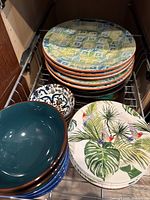 Stacked dinner plates, bowls and salad plates showing assorted patterns