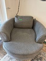 Front view of gray barrel accent chair showing seat and back cushion